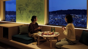 A modern interior with a large window overlooking a cityscape at night. - OMO7 Kochi by Hoshino Resorts (Kochi)