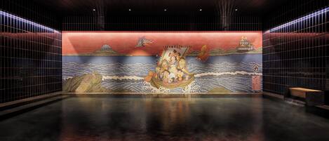 A spacious lobby with a traditional mural, tiled walls, and a polished floor.