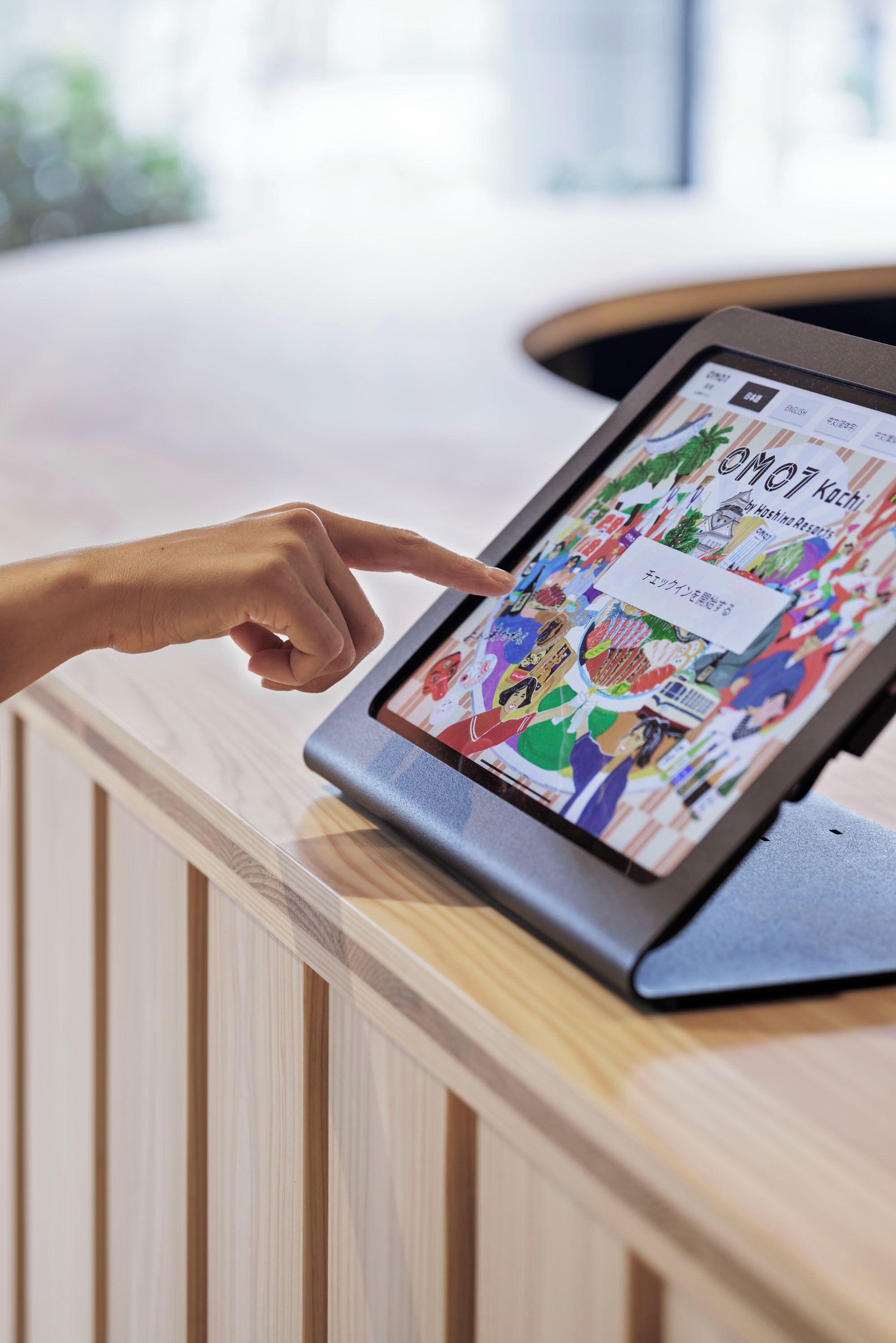 A tablet displaying a colorful manga on a wooden counter.