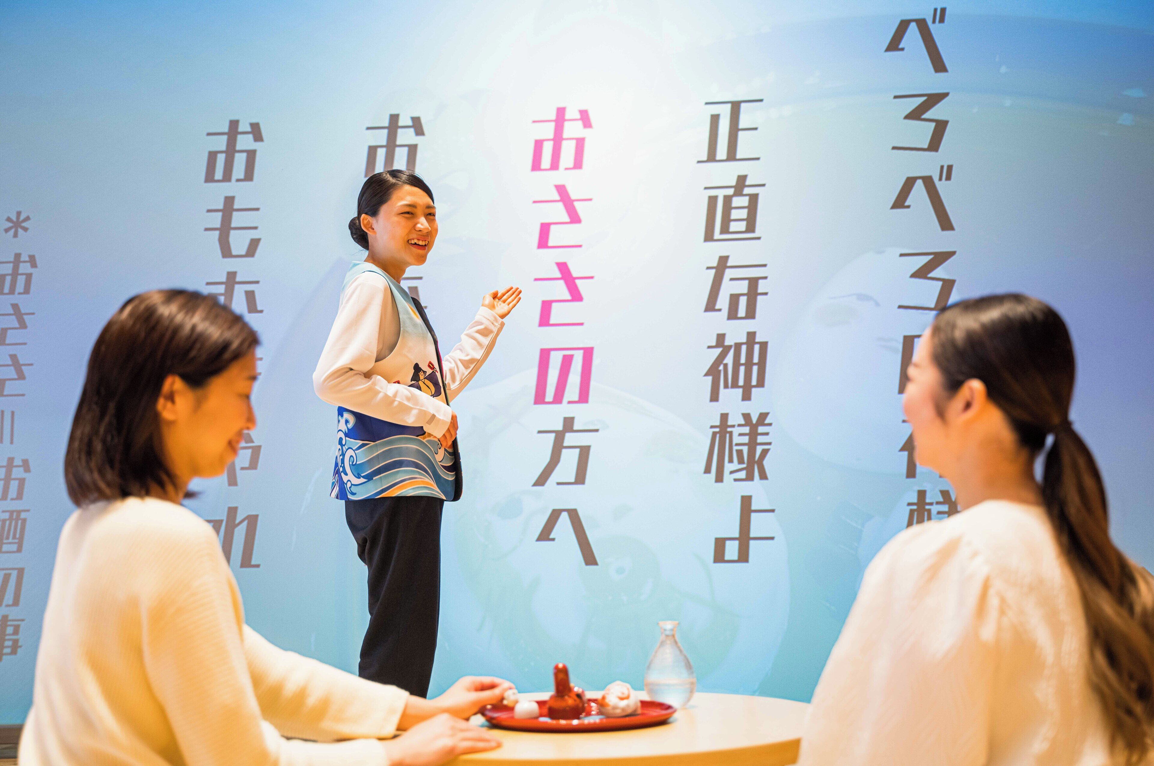 A person standing in front of a wall with text, possibly giving a presentation or speech.