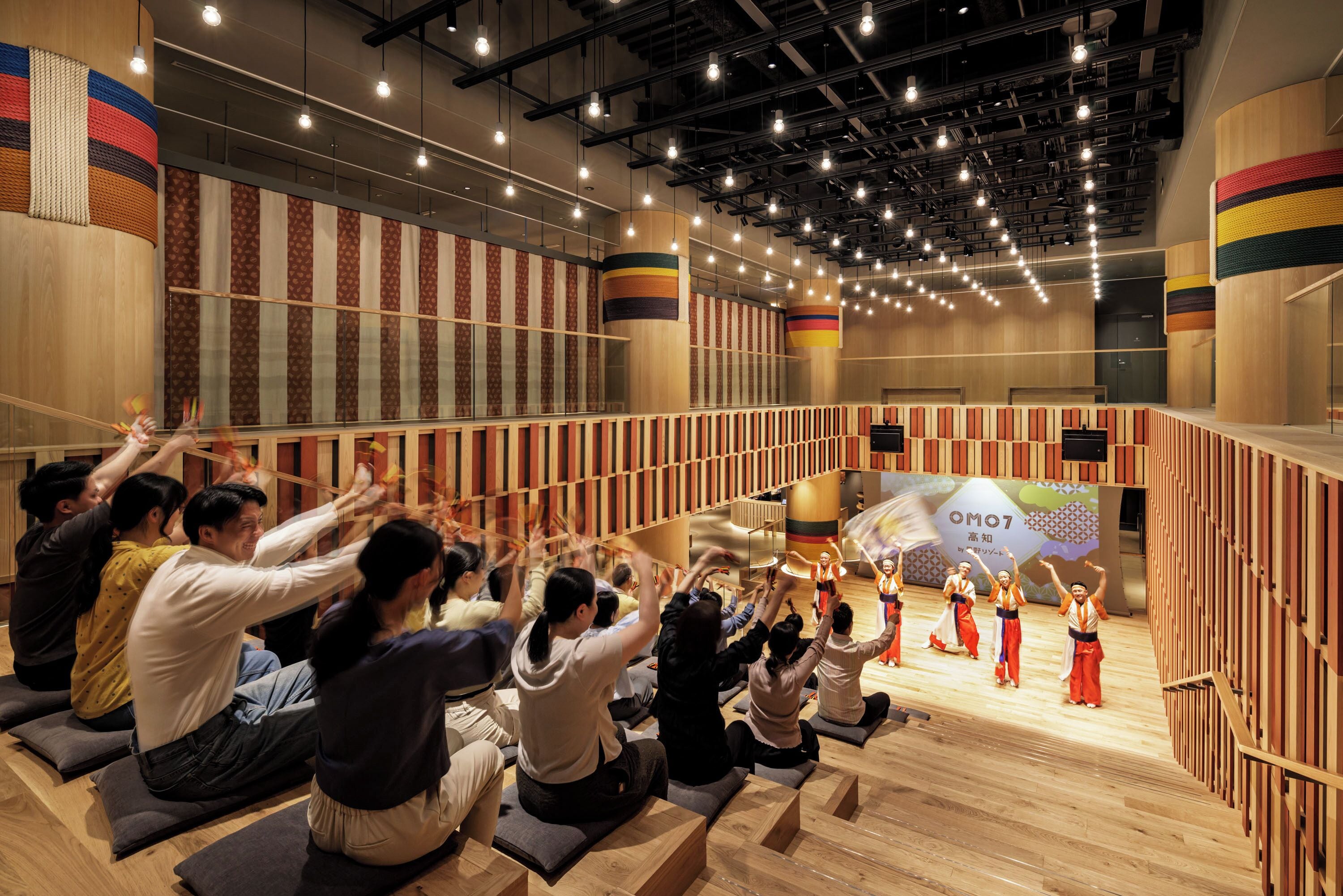 A spacious hall with tiered seating and a stage for performances.