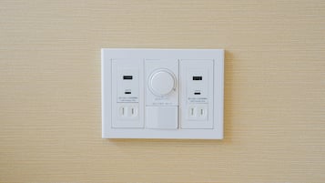 A white electrical panel with two USB PD ports and a circular dial, likely for controlling lighting or power.