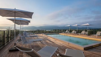 Outdoor pool, open 9:00 AM to 9:00 PM, pool umbrellas, pool loungers