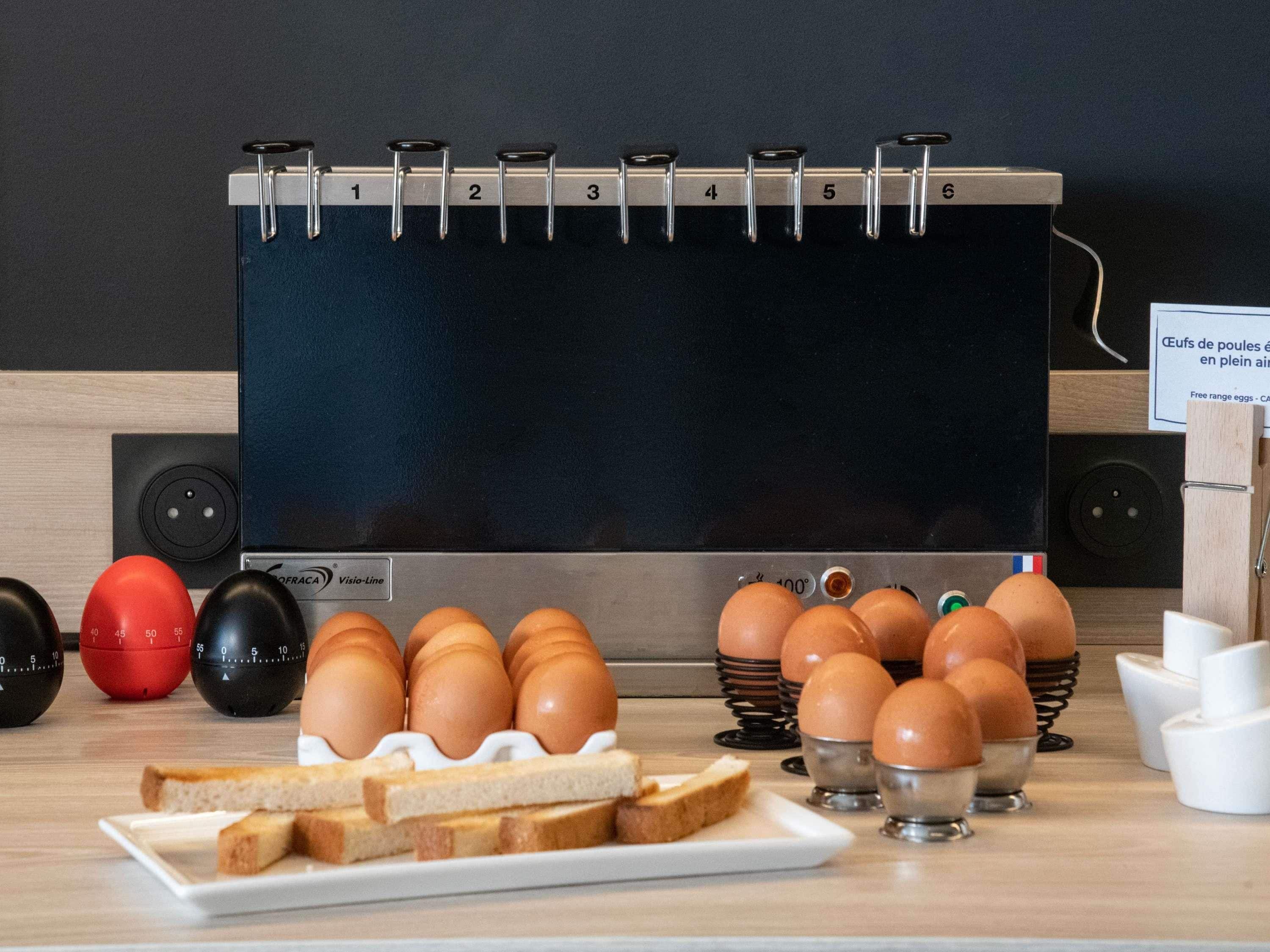 A kitchen with a blackboard, eggs, and bread.