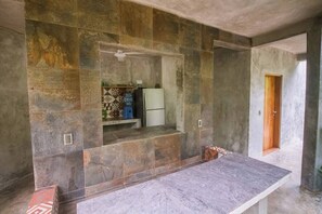 A kitchen with stone walls, a countertop, and a refrigerator. - Casa Catarina, AC, Garden, Pool, Private Villa (Buenavista)