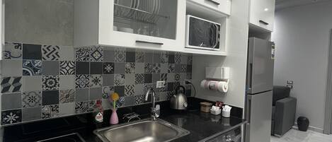 Fridge, microwave, stovetop, coffee/tea maker