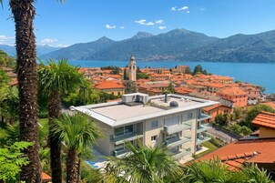Un pueblo costero con una imponente torre de iglesia, edificios modernos y una vista despejada del lago.
