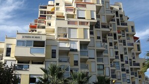 A multi-story building with balconies and a sign reading "LE TEMPLE DU SOLEIL". - VIEW OF THE MEDITERRANEAN SEA (La Grande-Motte)