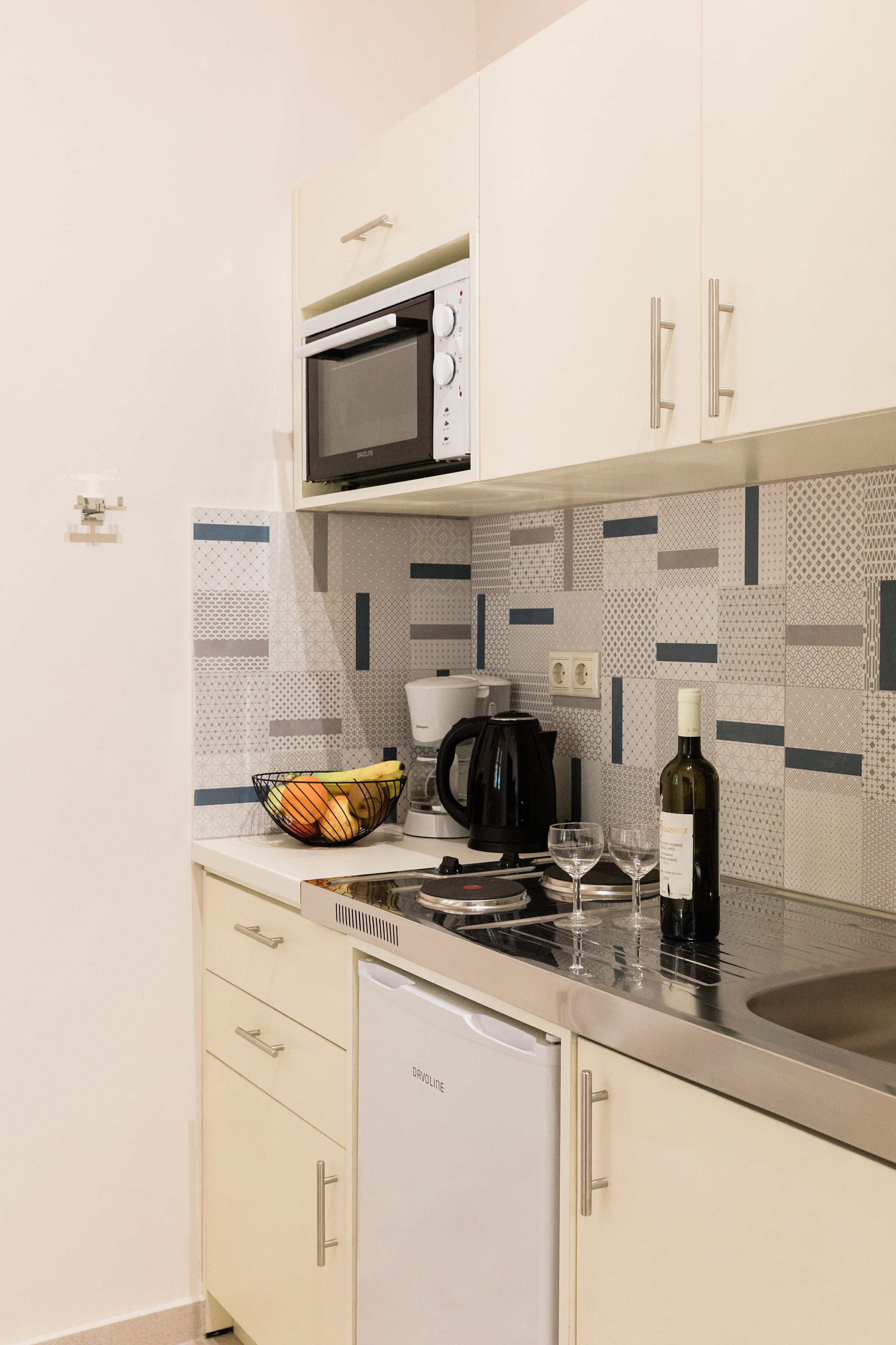 A modern kitchen with a microwave, coffee maker, and a dishwasher.