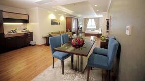 A modern hotel room with a dining area, a kitchen, and a living area. - Cairo Taj Hotels & Suites - Dokki (Giza)