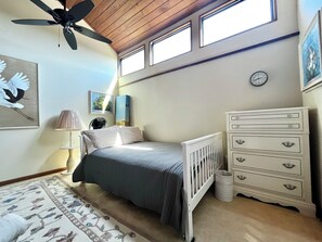 A bedroom with a bed, dresser, ceiling fan, and artwork. - BT 3942 Pond View Condo-Welcome to Paradise (Fort Pierce)