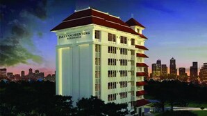 A high-rise building with a red roof and multiple balconies, labeled "Ziasanno Menteng Residences." - Giia Sanno Menteng (Jakarta)