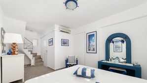 A bedroom with a bed, a desk, a chair, and a staircase. - Nataly's Apartment (Andros)