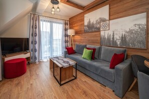 Apartment (C8) | Living area | Flat-screen TV, ping pong - Sun & Snow Resorts C Białka Tatrzańska (Bukowina Tatrzanska)