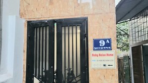 A gated entrance with a sign indicating 'Ruby Relax Home' and a contact number. - Ruby Relax Home (Hanoi)