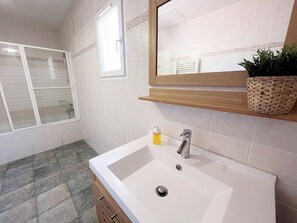 Shower, hair dryer, soap, toilet paper