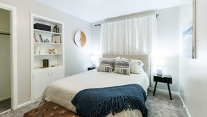A bedroom with a bed, a wardrobe, a nightstand, and a ceiling fan. - Walk to Groceries—Sleeps 8—Game Room + Patio + Parking for 4 (Lubbock)
