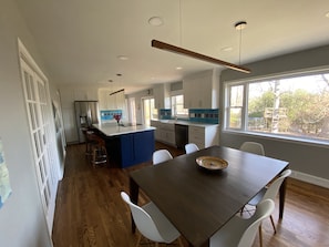 Enjoy cooking and dining in this well-equipped kitchen with a central island and stove, perfect for preparing meals.