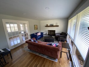 Relax in this inviting living room with a plush sofa, fireplace, and dining area.