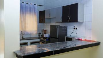 Standard Apartment, 1 King Bed, City View | Private kitchen | Fridge, microwave, oven, dishwasher