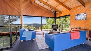 Relax in this spacious living area with a panoramic view of the lush landscape.