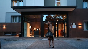 A modern building with a glass entrance, a visible reception desk, and a clear view of the interior. - Hotel Leonessa  (Brescia)