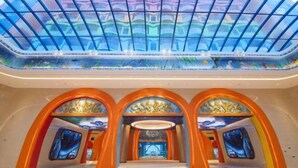 A spacious atrium with a high ceiling and a glass dome, featuring a central staircase and ornate arches. - Fuxian Lake Dolphin Bay Hotel (Cambrian Town Flagship Store) (Chengjiang)