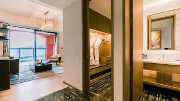 A modern hotel room with a large window, a walk-in closet, and a marble floor.