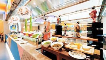 A buffet with various food items and traditional decorations.