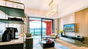 A modern living room with a large window, a coffee machine, a TV, and a sofa. - Fuxian Lake Dolphin Bay Hotel (Cambrian Town Flagship Store) (Chengjiang)