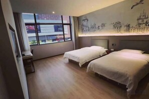 A hotel room with two beds, a desk, and a large window. - XM Butler Hotel (Jinjiang)