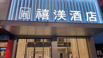 A hotel with a modern facade and illuminated signage.