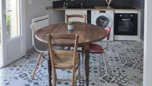 A compact kitchen with white cabinets, a built-in oven, and a washing machine. - 2 Bedroom Apartment in Saint-Georges-de-LuzenÃ§on (Saint-Georges-de-Luzençon)