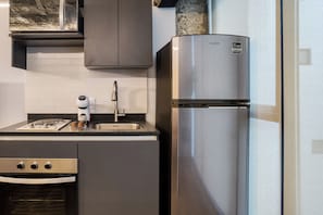 Industrial One-Bedroom Apartment | Private kitchen | Full-size fridge, microwave, oven, stovetop