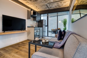 Industrial One-Bedroom Apartment | Living area | Smart TV - ULIV Apartments El Ángel (Mexico City)