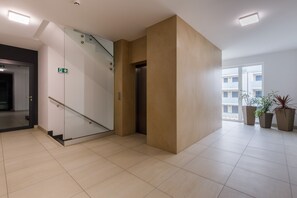 Elevator - Platinium Rewal Apartment by Renters (Rewal)