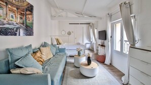 A modern living room with a sofa, coffee table, and artwork on the wall.