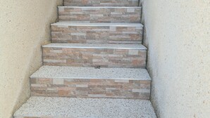 A staircase with stone steps and a beige wall. - Gorgeous 3 Bed En-Suite, Huge Roof Terrace overlooking Pool and La Marquesa Golf (Ciudad Quesada)