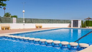 A swimming pool with a series of steps leading into it, benches, and a gazebo. - Gorgeous 3 Bed En-Suite, Huge Roof Terrace overlooking Pool and La Marquesa Golf (Ciudad Quesada)