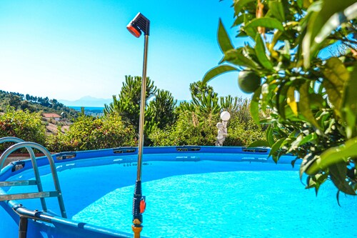 Vacation apartment with private garden, roof terrace and communal pool