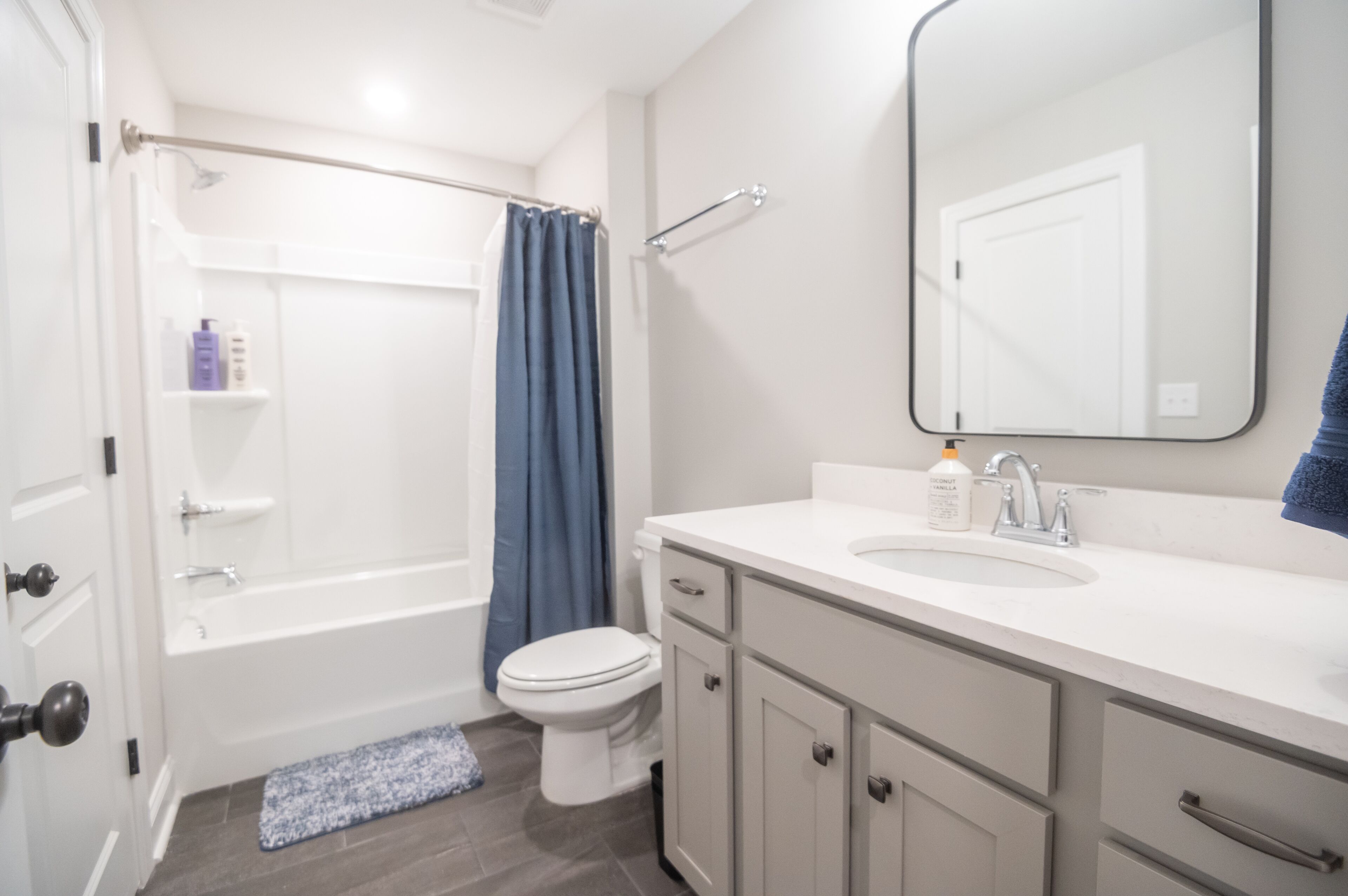 A bathroom with a bathtub, toilet, and sink.