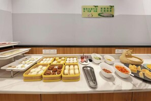 A buffet table with various food items and condiments. - Seaman Hotel (Chongqing Jiazhou Hongqi Hegou Light Rail Station) (Chongqing)