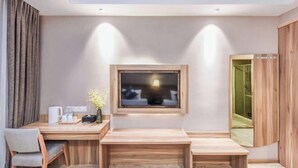 A modern room with a wooden desk, a chair, a small table, a window, and a mirror. - Seaman Hotel (Chongqing Jiazhou Hongqi Hegou Light Rail Station) (Chongqing)