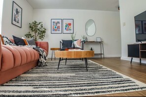 Relax in this stylish living room with a plush sofa, coffee table, and area rug.