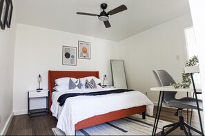 Cozy retreat with a central bed, bedside tables, and a ceiling fan.