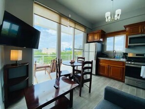 Enjoy meals in the kitchen with a dining table and chairs, and relax in front of the flat-screen TV.