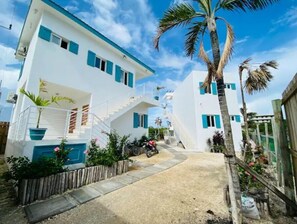 Stylish two-story home with a covered outdoor area and garden, perfect for relaxation.