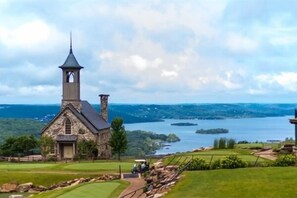 Situated in a lush, green setting, this chapel offers a serene escape surrounded by well-maintained grass and a golf course.