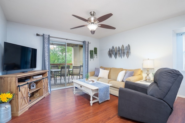 Living room with natural light and comfortable seating.
