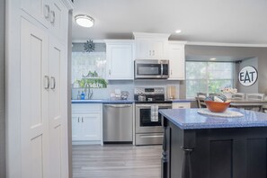 Enjoy cooking in this well-equipped kitchen with a dishwasher, microwave, oven, and sink.